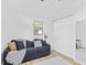 Cozy bedroom featuring a comfortable couch, light wood floors, and white closets at 5570 Paradise Ct, Martinsville, IN 46151