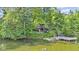 Picturesque lake home surrounded by trees, featuring a dock and lake access at 5570 Paradise Ct, Martinsville, IN 46151