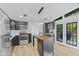Open kitchen with stainless steel appliances, subway tile backsplash, butcher block island and access to the backyard at 5570 Paradise Ct, Martinsville, IN 46151