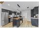 Bright eat-in kitchen featuring stainless steel appliances, black cabinets, light wood flooring, and large butcher block island at 5570 Paradise Ct, Martinsville, IN 46151