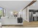 Open-concept living space features modern furnishings, wood beam detail and views of kitchen at 5570 Paradise Ct, Martinsville, IN 46151