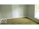 This bedroom has carpet floors and features a large window for great natural light at 620 S 2Nd St, Noblesville, IN 46060