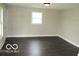 A spacious and sunlit living room with modern paint and dark wood floors at 620 S 2Nd St, Noblesville, IN 46060