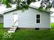 View of back of house and walkout basement, white siding, window, door, and small set of steps at 620 S 2Nd St, Noblesville, IN 46060
