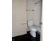A white toilet sits on the dark wood patterned bathroom floor at 6322 Commons Dr, Indianapolis, IN 46254