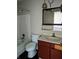 Bathroom featuring a vanity, toilet, and a tile-surround tub/shower combo at 6322 Commons Dr, Indianapolis, IN 46254