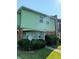 Two-story home with green siding, brick accents, satellite dish, and well-maintained landscaping at 6322 Commons Dr, Indianapolis, IN 46254