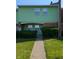 Charming two-story home with green siding, brick accents, and well-maintained landscaping at 6322 Commons Dr, Indianapolis, IN 46254