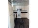 Traditional-style kitchen with white appliances, dark countertops, and vinyl flooring at 6322 Commons Dr, Indianapolis, IN 46254