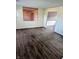 Spacious living room featuring neutral walls and wood-look flooring at 6322 Commons Dr, Indianapolis, IN 46254