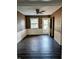 Inviting living room featuring a ceiling fan, wood-look floors, and a walkout to backyard at 6322 Commons Dr, Indianapolis, IN 46254