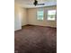 Spacious carpeted main bedroom featuring two sunny windows at 6322 Commons Dr, Indianapolis, IN 46254