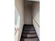 Interior staircase with a light colored handrail and dark stained treads at 6322 Commons Dr, Indianapolis, IN 46254