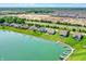 Scenic aerial of a neighborhood by a lake, showcasing green spaces and waterfront properties at 6882 Bladstone Rd, Noblesville, IN 46062