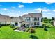 A large backyard area featuring a stone patio, outdoor seating, and a fire pit. Perfect for entertaining at 6882 Bladstone Rd, Noblesville, IN 46062