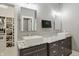 Elegant bathroom featuring double sinks with granite countertops and a closet with custom shelving at 6882 Bladstone Rd, Noblesville, IN 46062