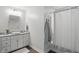 Clean bathroom featuring a white vanity with granite countertops, decorative faucet, shower and neutral walls at 6882 Bladstone Rd, Noblesville, IN 46062