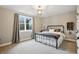 Cozy bedroom with neutral colored walls, carpeted floor, a decorative light fixture and window with blinds at 6882 Bladstone Rd, Noblesville, IN 46062