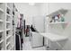 Spacious walk-in closet featuring custom shelving, laundry machines, and ample storage space at 6882 Bladstone Rd, Noblesville, IN 46062