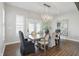 Bright dining room featuring a modern chandelier, large windows, and elegant dining set at 6882 Bladstone Rd, Noblesville, IN 46062