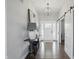 Elegant entryway featuring a chandelier, console table, and sliding barn door at 6882 Bladstone Rd, Noblesville, IN 46062