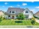Beautiful two-story modern farmhouse featuring a manicured lawn and inviting front porch at 6882 Bladstone Rd, Noblesville, IN 46062