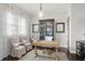 Bright home office featuring a rustic desk, ample natural light, and stylish decor at 6882 Bladstone Rd, Noblesville, IN 46062