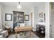 Cozy home office with a wooden desk, display cabinet, and comfortable seating at 6882 Bladstone Rd, Noblesville, IN 46062