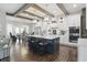 Bright kitchen and eat-in area featuring wood beams, a large island with seating at 6882 Bladstone Rd, Noblesville, IN 46062