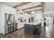 Stylish kitchen boasts stainless steel appliances, white cabinetry and a large island at 6882 Bladstone Rd, Noblesville, IN 46062