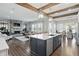 An open-concept kitchen with island, stone fireplace in the living room, and dining area at 6882 Bladstone Rd, Noblesville, IN 46062
