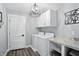 Well-lit laundry room with modern washer and dryer and storage cabinets at 6882 Bladstone Rd, Noblesville, IN 46062