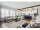 Spacious living room with exposed wood beams, open floor plan, and stylish furnishings at 6882 Bladstone Rd, Noblesville, IN 46062