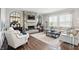 Inviting living room with a stone fireplace, plush seating, and abundant natural light at 6882 Bladstone Rd, Noblesville, IN 46062
