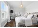 Comfortable main bedroom featuring large windows, hardwood floors and neutral decor at 6882 Bladstone Rd, Noblesville, IN 46062