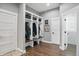Well-organized mudroom with built-in shelving, bench, and storage for coats and shoes at 6882 Bladstone Rd, Noblesville, IN 46062