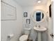 Bright, well-decorated bathroom featuring a pedestal sink, modern fixtures, and decor at 6883 Honeysuckle Way, Pendleton, IN 46064