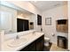 Modern bathroom featuring double sinks, granite countertops, a framed mirror, and black shower curtain at 6883 Honeysuckle Way, Pendleton, IN 46064