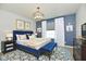 Beautiful bedroom featuring a blue bedframe with gold accents and a patterned rug at 6883 Honeysuckle Way, Pendleton, IN 46064
