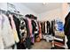 Walk-in closet with wire shelving, hanging clothes, and storage boxes on the floor at 6883 Honeysuckle Way, Pendleton, IN 46064