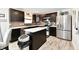 Modern kitchen featuring dark cabinetry, stainless steel appliances, and a center island with a white countertop at 6883 Honeysuckle Way, Pendleton, IN 46064
