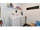Functional laundry room equipped with a washer, dryer, storage, and practical shelving at 6883 Honeysuckle Way, Pendleton, IN 46064