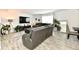 Spacious living room features a sectional sofa, large TV, and ample natural light at 6883 Honeysuckle Way, Pendleton, IN 46064