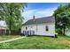 Home's backyard presents a white picket fence and lush lawn space perfect for outdoor activities at 701 E Memorial Dr, Muncie, IN 47302