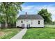 Cozy backyard features freshly painted white siding and a new backyard deck at 701 E Memorial Dr, Muncie, IN 47302
