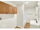 Well-lit bathroom features hardwood style floors, wooden cabinets and a built in tub at 701 E Memorial Dr, Muncie, IN 47302