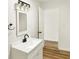 Modern bathroom featuring a white sink, black faucet, and hardwood style floors at 701 E Memorial Dr, Muncie, IN 47302