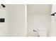 Clean, white bathroom with modern fixtures and a minimalist design at 701 E Memorial Dr, Muncie, IN 47302