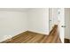 Bedroom with laminate floors, white walls, trim, and entry to the hallway at 701 E Memorial Dr, Muncie, IN 47302