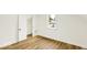 A bedroom with laminate floors, a closet, and a window providing natural light at 701 E Memorial Dr, Muncie, IN 47302